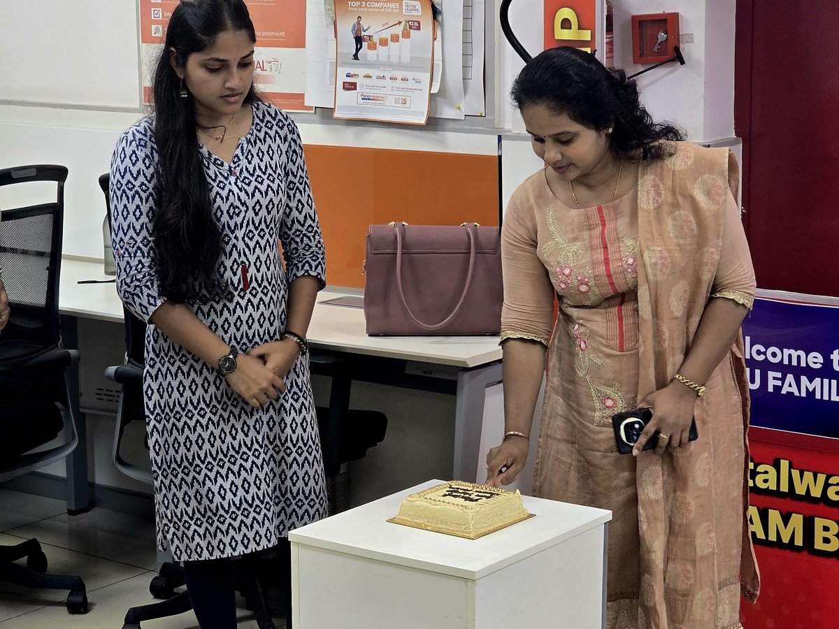 Sheenu Sathish cutting a celebration cake at the ICICI Prudential Life branch